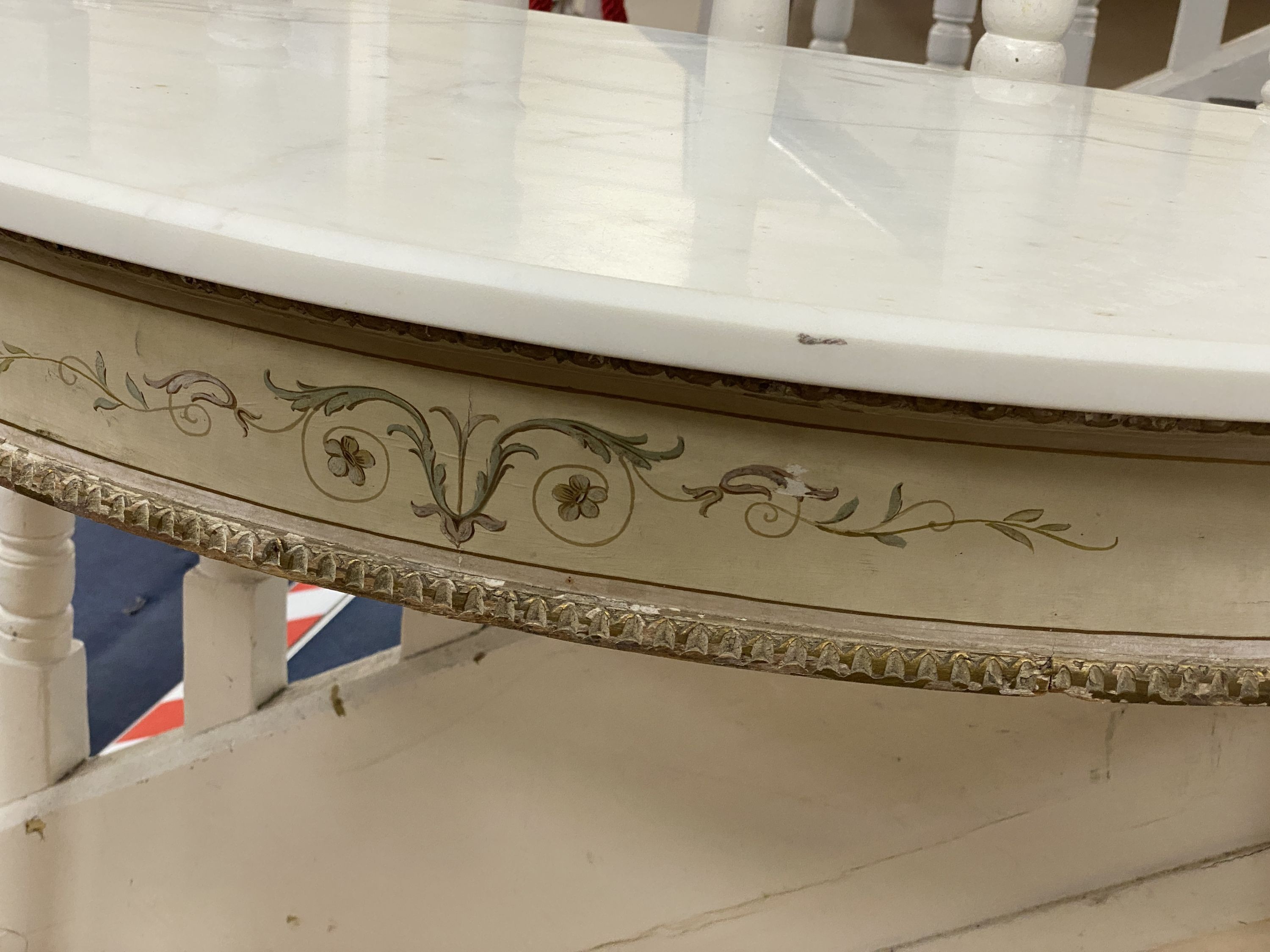 A pair of French marble topped demi lune console tables, with later veined white marble tops and parcel gilt painted underframes, width 100cm depth 47cm height 79cm